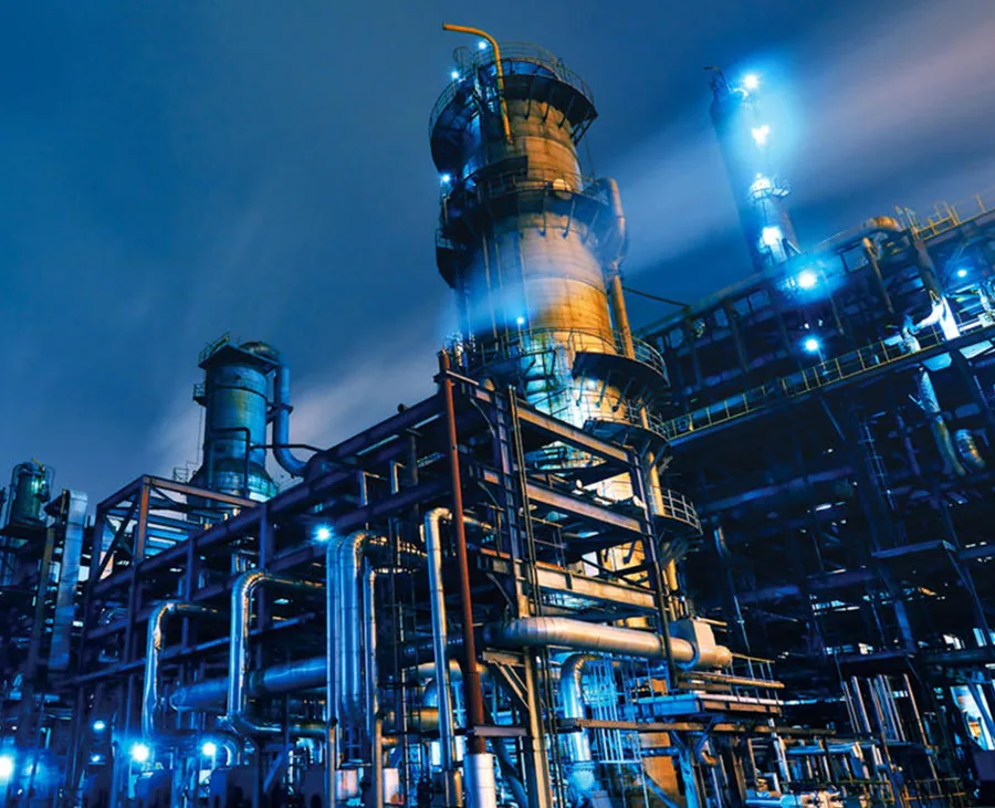 Power plant towers and pipework at night